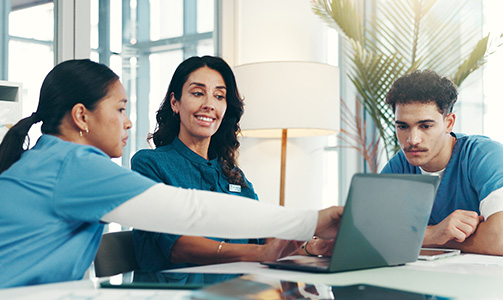 Technicians help hospital staff with Wi-Fi network on laptop